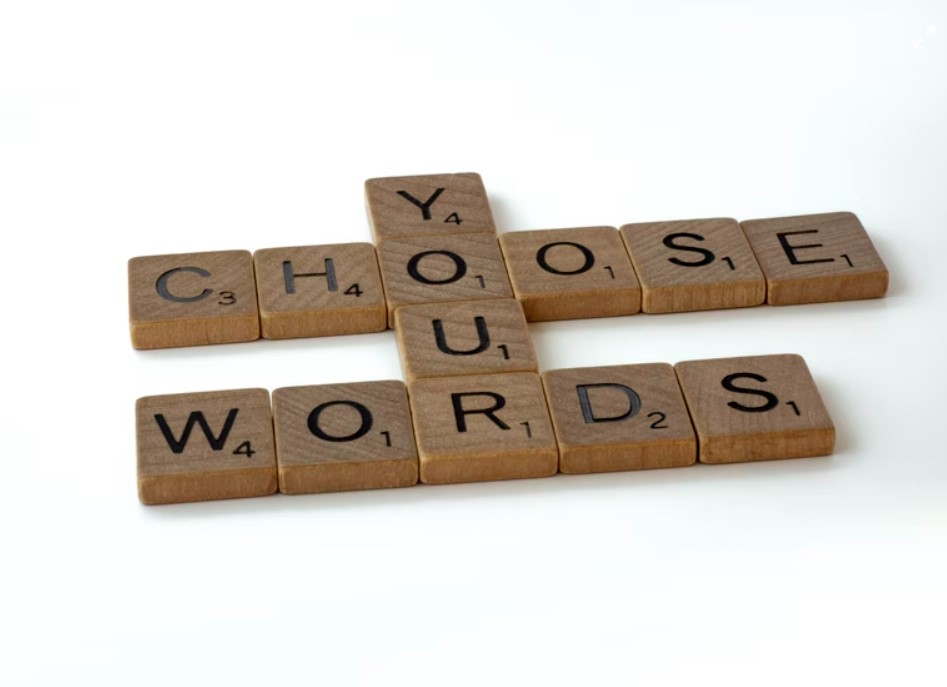 a close up of a crossword puzzle on a white surface spelling choose your words ads interactive ad monetization platform