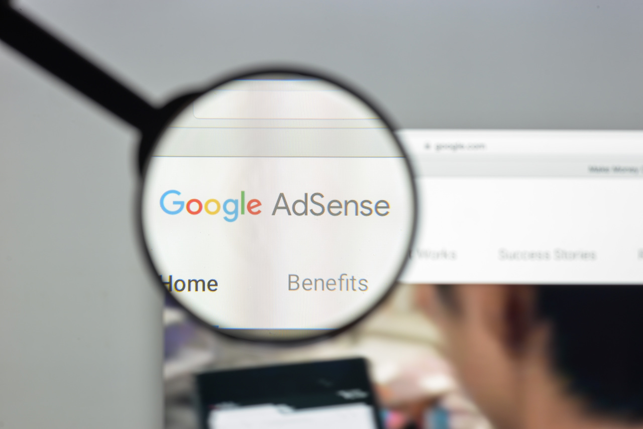 Google Adsense logo under magnifier, ads interactive ad monetization platform